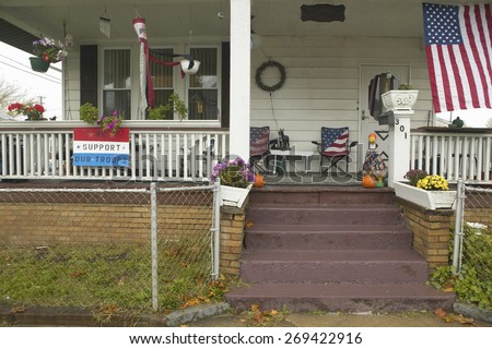 A rural house with American flag and We Support Our Troops sign in Ohio
