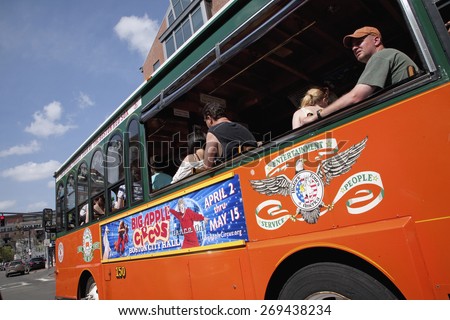 Bright Orange Tour Bus drives to historic sites of Boston, MA.