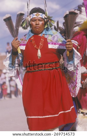 A Native American woman in traditional costume at the Corn Dance ceremony, Santa Clara Pueblo, NM