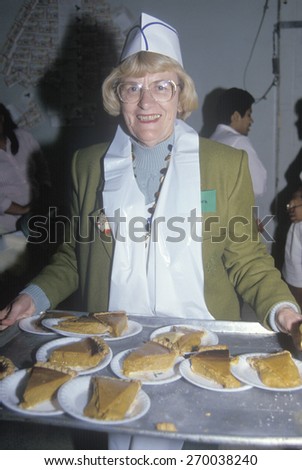 Volunteer serving pumpkin pie at homeless shelter for Christmas, Los Angeles, California