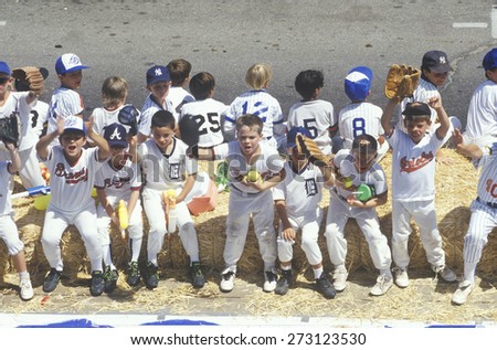 Boys sitting on bench and on sidelines, Little League Baseball game, Ojai, CA