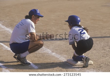 Coach with player on base, Girls Softball game, Brentwood California