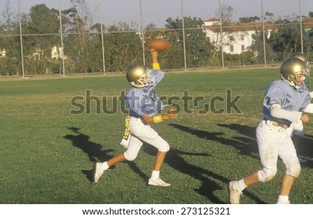 Junior League Football player catching football during practice, Brentwood, CA