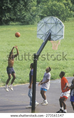 Groups of African-American youths playing street basketball, Blue Ridge, Virginia