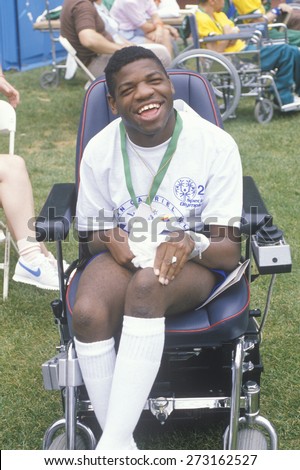 Handicapped African American Athlete cheering at finish line, Special Olympics, UCLA, CA