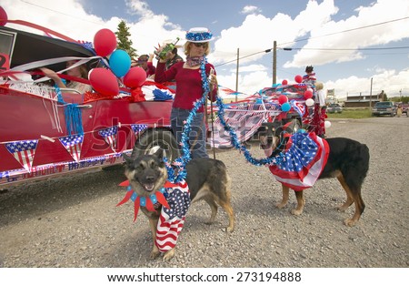 Woman with patriotic dogs at Fourth of July Parade, in Lima Montana