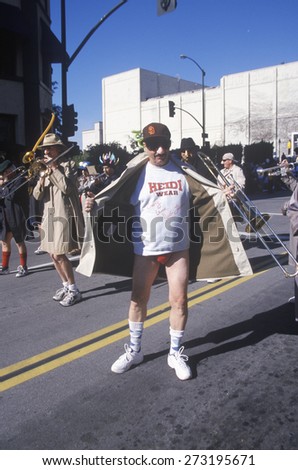 Man wearing a trench coat exposing himself at the Doo Dah Parade, Pasadena, California