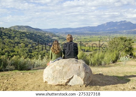 Couple sits and meditates at Meditation Mount\'s Point overlooking the Ojai Valley, CA