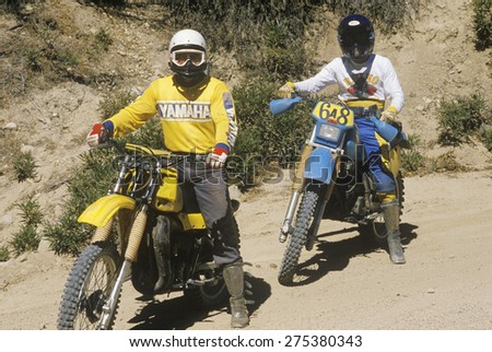 Two dirt bike riders on their off-road motorcycles