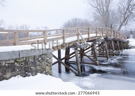 Old North Bridge in winter snow, Concord River, Concord, Ma., New England, USA, the historical site of the Battle of Concord, the first day of battle in the American Revolutionary War