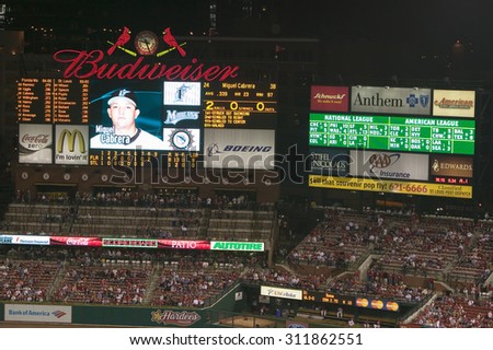In a night game and a light rain mist, a scoreboard is seen at the 3rd Busch Stadium, St. Louis, Missouri on August 29, 2006