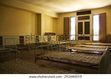 Beds in an abandoned old room in semi darkness