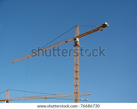 Steel crane, general view over blue sky