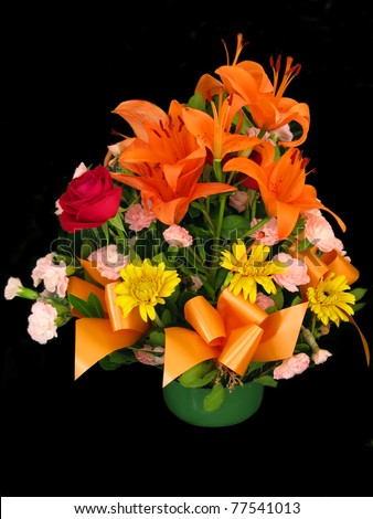 Different flowers bouquet in a basket, isolated in black