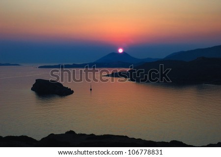 Sunset at Cape Sounion , located 69 kilometers of Athens , Greece . The site is a popular day-excursion for tourists from Athens, with sunset over the Aegean Sea, as viewed from the ruins .