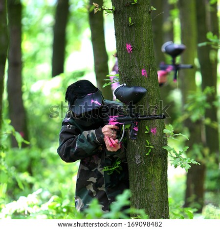 Paintball game in wood in summer