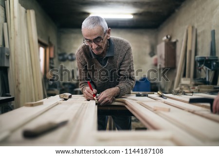 Similar – Image, Stock Photo Senior male woodworker working in garage