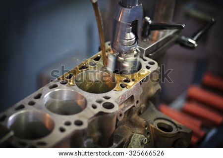 Closeup shot of working industrial machine. This machine is used for the treatment of automotive and marine / boat engines. Visible grain.