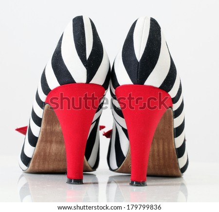 women\'s fashion shoes. zebra pattern. red heel natural material