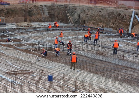 workers in the construction of the building foundation. laying warm floors. Belarus, Minsk, Oktober,8,2014