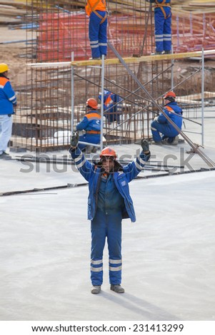 Renaissance construction workers reinforce fitting. The concrete foundation of the hotel building. Worker Turkish nationality.Belarus,Minsk,Novem ber,1,2014