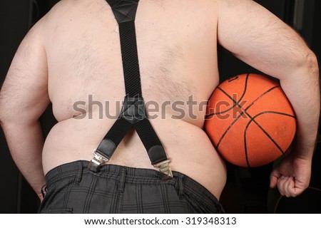 man holding basketball ball . Big belly obese men. Disease and metabolic disorders.