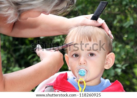hair cutting first one-year-old child - trimming bangs