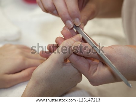 Pair of  hands having the nails filed