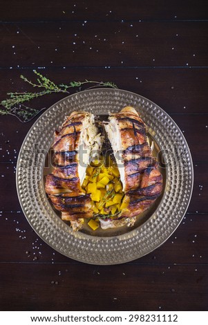 Bacon wrapped roasted chicken stuffed with butternut squash and herbs