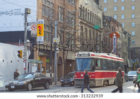 TORONTO,CANADA-March 15,2012: A view of downtown Toronto with the 501, an east-west 24km  streetcar route operated by the Toronto Transit Commission (TTC), the longest  in North America.
