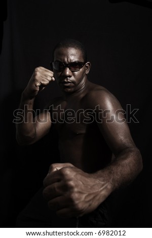 Portrait of young aggressive afromerican man with sunglasses - isolated on black