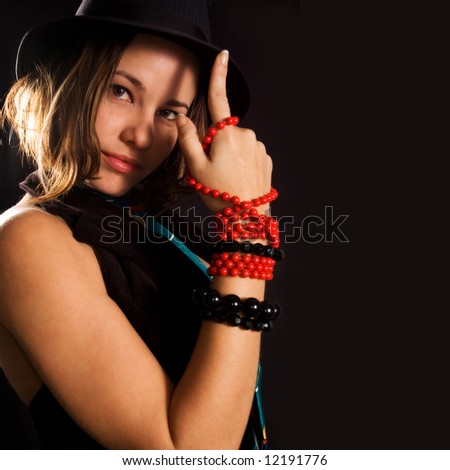 Portrait of young woman in funky trendy fashion - isolated on black