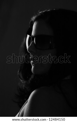 Black and white portrait of young woman wearing sunglasses