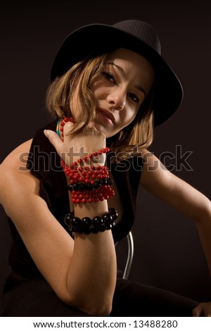 Portrait of funky girl in trendy fashion with hat and tie