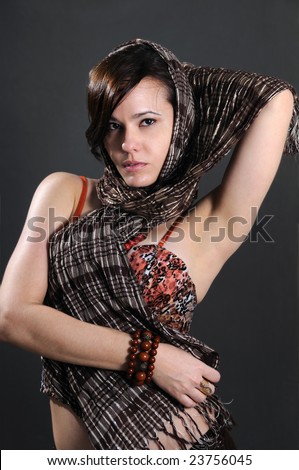 Portrait of young beautiful fashion model posing with head scarf