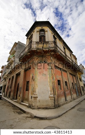 Corner in Havana street with eroded building facade against blue sky, cuba