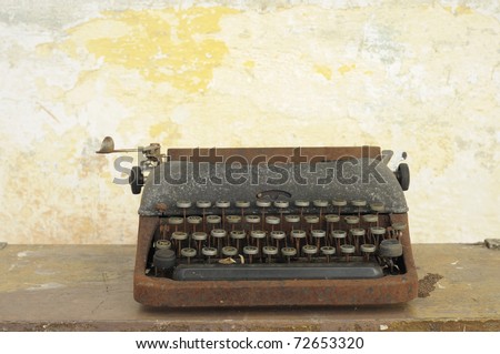 Old type writing machine against grunge wall