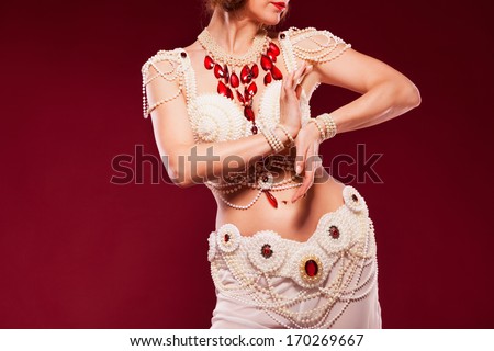 beautiful oriental dancer in a white pearl  costume