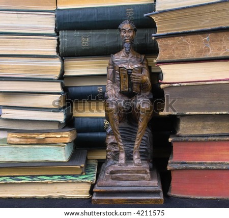 books and wooden sculpture of a reading man