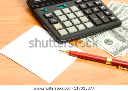 Pen, calculator and money close up.