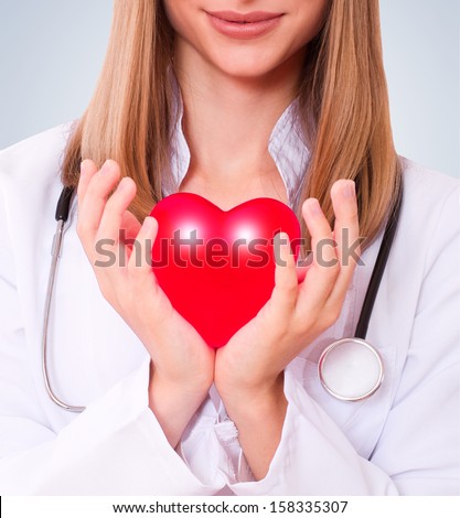 The doctor holding heart. Health insurance or love concept.