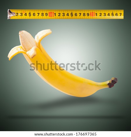 Large banana and measuring tape as image of man's penis. Concept of men's health