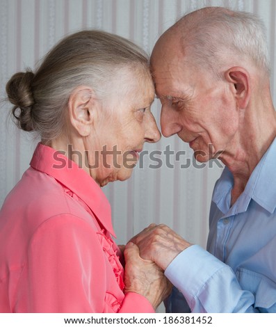 Closeup portrait of smiling elderly couple Old people holding hands. Concept of marital fidelity, providing for old age, reliability, care for the elderly, love confession