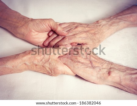 Old people couple holding hands. Closeup. Elderly man, woman