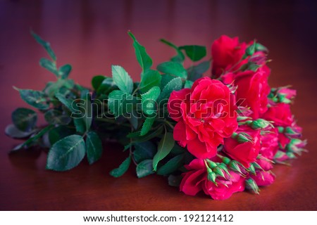 Spring flowers bouquet red rose on wooden table. Beautiful flowers as gift for holiday. Greeting card Happy Mother\'s Day, Valentine. Free space for text.