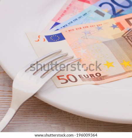 Cash euro lying on the plate. ?oncept you want to eat - go to work