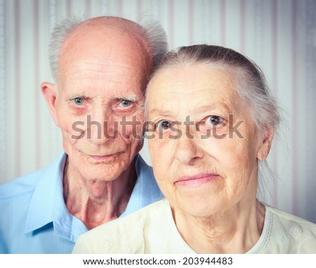 Portrait positive adult couple smiling at the camera. Elderly couple. Old people holding hands. Concept of marital fidelity, providing for old age, reliability. Happy family at home