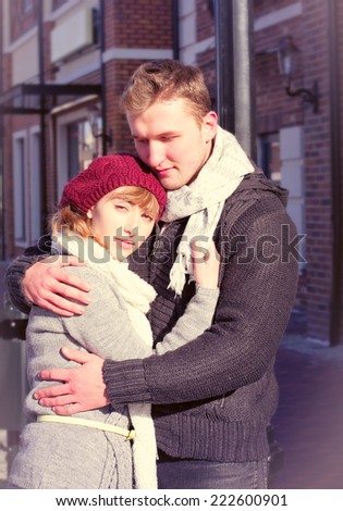 Young people walking around city in winter. Couple in cold winter weather. Love and kiss. Young people. Snow lovers kiss city. Fashion clothing. bright picture of young couple in winter clothes