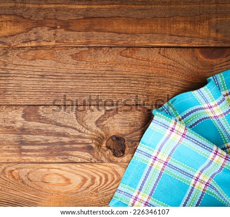 Wood texture background. Wooden table covered with tablecloth cloth checkered plaid red. View from top. Empty tablecloth for product montage for recording menu, recipe. Free space for your text
