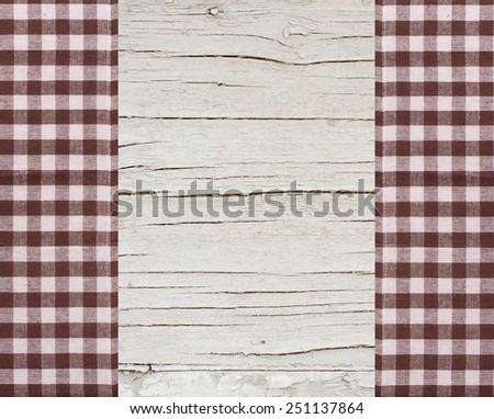 Pure notebook for recording menu, recipe on checkered tablecloth tartan. Wooden table close up view from top